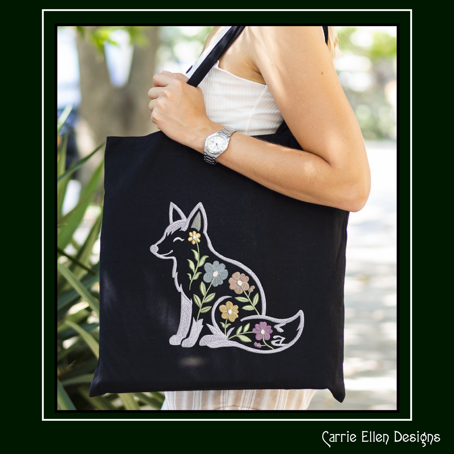 Black tote bag with an embroidery design of a Floral fox embroidery design featuring woodland fox with flowers stitch file for nursery décor, rustic projects, quilts, and cottage-core crafts.