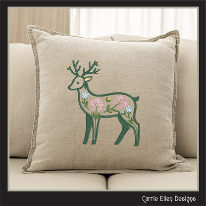 Decorative pillow with a deer and floral design on a beige couch.