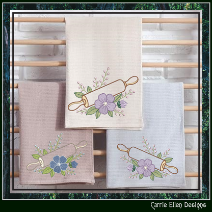 Kitchen towels with The Floral Rolling Pin Machine Embroidery Design  on a wooden rack.