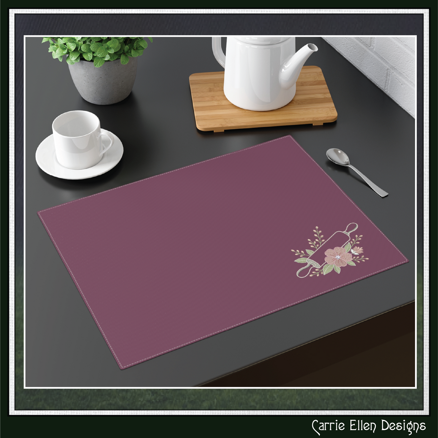 Placemat with The Floral Rolling Pin Machine Embroidery Design  on a dark surface with tea set items.