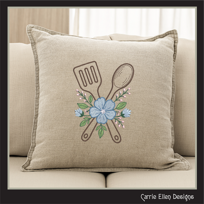Beige pillow with Decorative design of Floral Kitchen Spatula and Spoon Machine Embroidery Design features a beautifully styled crossed spatula and spoon, accented with soft floral details