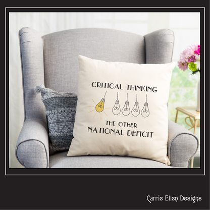 Decorative pillow with 'Critical Thinking: The Other National Deficit' text on a gray armchair.